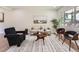 Bright and airy living room with hardwood floors, neutral tones, modern furnishings, and large windows at 1245 Troy St, Aurora, CO 80011