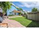 Picturesque backyard featuring a lush lawn, patio, storage shed, and mature trees at 2645 Osceola St, Denver, CO 80212