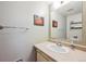 This bathroom features a single sink with solid surface countertops, white cabinets and modern fixtures at 2645 Osceola St, Denver, CO 80212