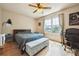 Bright bedroom with hardwood floors, ceiling fan, and a large window, perfect for relaxing and unwinding at 2645 Osceola St, Denver, CO 80212