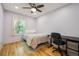 Cozy bedroom featuring hardwood floors, ceiling fan, natural light, and a desk area at 2645 Osceola St, Denver, CO 80212