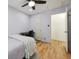 Bright bedroom showing hardwood floors, ceiling fan, a door to the hallway, and a desk area at 2645 Osceola St, Denver, CO 80212