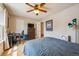 Comfortable bedroom with hardwood floors, ceiling fan, and large window at 2645 Osceola St, Denver, CO 80212