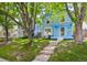 Charming two-story blue home with a welcoming front porch and beautiful, mature trees at 2645 Osceola St, Denver, CO 80212
