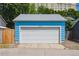 Detached garage with a modern white garage door and updated blue paint at 2645 Osceola St, Denver, CO 80212