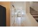 Inviting hallway with tile flooring leading to the kitchen, and stairs on the right at 2645 Osceola St, Denver, CO 80212