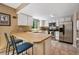 This kitchen features a breakfast bar, stainless steel appliances, and light, neutral colors at 2645 Osceola St, Denver, CO 80212