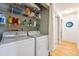 Laundry room featuring a side-by-side washer and dryer, and shelves for storage at 2645 Osceola St, Denver, CO 80212