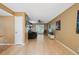 Spacious living room with light hardwood floors, ceiling fan, and abundant natural light at 2645 Osceola St, Denver, CO 80212
