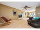 Spacious living room featuring hardwood floors, a ceiling fan, and sliding doors to the outside at 2645 Osceola St, Denver, CO 80212