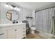 Modern bathroom with a sleek vanity, stylish mirror, and a shower with black and white curtain at 420 Zang St # 3-208, Lakewood, CO 80228