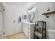 Bright bathroom featuring modern fixtures, including a black framed round mirror and a stylish vanity at 420 Zang St # 3-208, Lakewood, CO 80228
