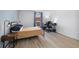 Well-lit bedroom features a comfortable bed, a modern desk, and ample natural light at 420 Zang St # 3-208, Lakewood, CO 80228