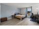 Light filled bedroom with a large window, modern furniture, and serene blue walls at 420 Zang St # 3-208, Lakewood, CO 80228