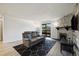 Inviting living room with a stone fireplace, modern decor, and sliding glass door at 420 Zang St # 3-208, Lakewood, CO 80228