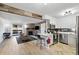 Open floor plan showcasing living room with stone fireplace and a modern kitchen with stainless appliances at 420 Zang St # 3-208, Lakewood, CO 80228