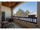 Private balcony with treetop views and outdoor seating at 18959 E Warren Dr # F108, Aurora, CO 80013