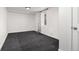 Clean and spacious basement area featuring new carpeting and a window at 6005 E Iowa Ave, Denver, CO 80224