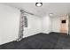 Finished basement with new carpet, neutral walls, and natural light at 6005 E Iowa Ave, Denver, CO 80224