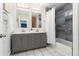 Bathroom features double vanity, gray cabinets, tiled floors, shower and stylish mirrors at 6005 E Iowa Ave, Denver, CO 80224