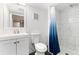 Tidy bathroom features a shower with tiling and updated vanity at 6005 E Iowa Ave, Denver, CO 80224