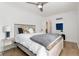 Bright bedroom features wood floors, ceiling fan, and lots of natural light at 6005 E Iowa Ave, Denver, CO 80224
