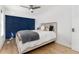 Bedroom features modern ceiling fan, wood floors, neutral color scheme, and comfortable furnishings at 6005 E Iowa Ave, Denver, CO 80224