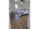 Bright bedroom featuring a ceiling fan, light wood flooring, and large window at 6005 E Iowa Ave, Denver, CO 80224
