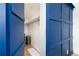 View of walk-in closet with hanging rods and a blue paneled wall at 6005 E Iowa Ave, Denver, CO 80224