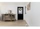 Inviting entryway with a mirrored console table, decorative artwork, and hardwood floors at 6005 E Iowa Ave, Denver, CO 80224