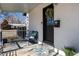 Inviting front porch with bench and decorative floral wreath on door offers curb appeal at 6005 E Iowa Ave, Denver, CO 80224