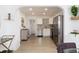 Modern kitchen with stainless steel appliances, white cabinets, and adjacent living area at 6005 E Iowa Ave, Denver, CO 80224