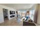 Bright and airy living room with large windows, stylish furniture, and hardwood floors at 6005 E Iowa Ave, Denver, CO 80224