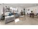 Bright, open-concept living area with hardwood floors, modern furniture, and lots of natural light at 6005 E Iowa Ave, Denver, CO 80224