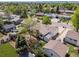 An aerial view captures a charming home nestled among lush greenery, showcasing its well-maintained backyard at 1634 S King St, Denver, CO 80219