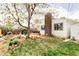 Spacious backyard featuring a patio, outdoor seating, lush lawn, and mature trees at 1634 S King St, Denver, CO 80219