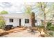 Inviting backyard with a wooden deck, stone patio, outdoor dining set, and well-manicured lawn at 1634 S King St, Denver, CO 80219