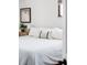 A bright bedroom with neutral colors, decorative pillows, and natural light at 1634 S King St, Denver, CO 80219