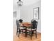 Elegant dining room with a classic table, black chairs, and stylish lighting fixture at 1634 S King St, Denver, CO 80219