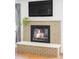 Living room fireplace with light brick surround and stone hearth at 1634 S King St, Denver, CO 80219