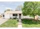 Charming single-story home with a well-manicured lawn and lush landscaping at 1634 S King St, Denver, CO 80219