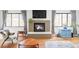 A full view of the living room space featuring a fireplace and large windows at 1634 S King St, Denver, CO 80219