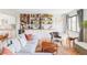 Open living room with custom built-in shelving, window seat, and hardwood floors at 1634 S King St, Denver, CO 80219