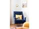 Cozy living room detail with a comfortable chair, soft lighting, and hardwood floors at 1634 S King St, Denver, CO 80219