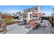 Backyard patio featuring an umbrella, dining table, seating, and a retaining wall at 7745 Grant St, Denver, CO 80229