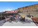 Backyard area features a fire pit and outdoor seating beneath a striped umbrella at 7745 Grant St, Denver, CO 80229