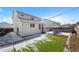 A home's backyard with a hot tub, grill, seating, and a retaining wall at 7745 Grant St, Denver, CO 80229