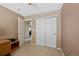 Comfortable bedroom with neutral carpet, closet, and a private doorway at 7745 Grant St, Denver, CO 80229