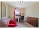 Comfortable bedroom features natural light, carpet, and a bean bag chair at 7745 Grant St, Denver, CO 80229