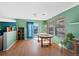 Sun-filled dining room with hardwood floors and a large wooden table at 7745 Grant St, Denver, CO 80229